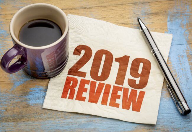 2019 year review text on a napkin with a cup of coffee, end of year business concept