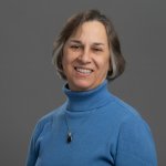 headshot of Susan Swider in a blue turtleneck