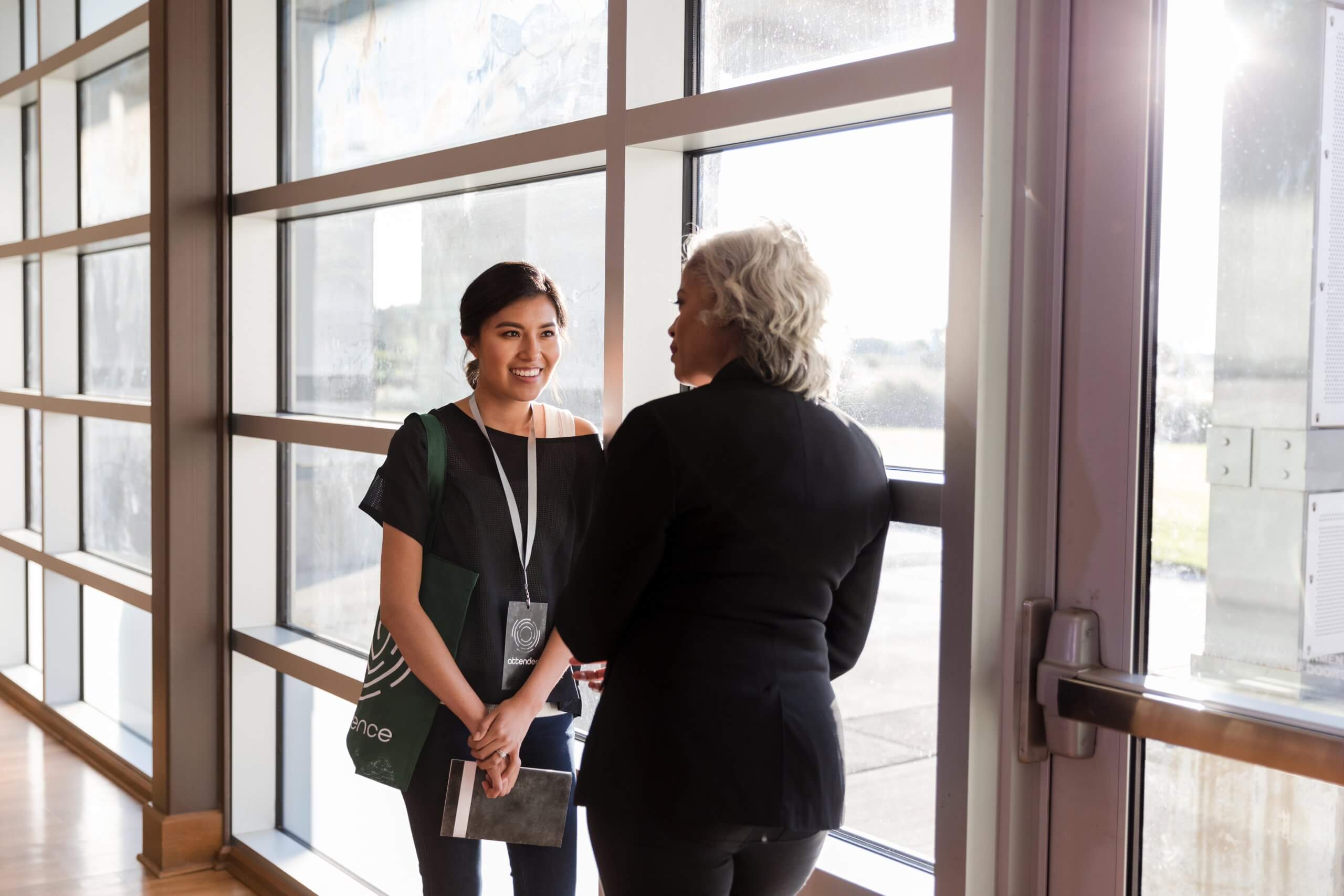 Mid adult woman listens eagerly to mature conference speaker | Campaign for  Action